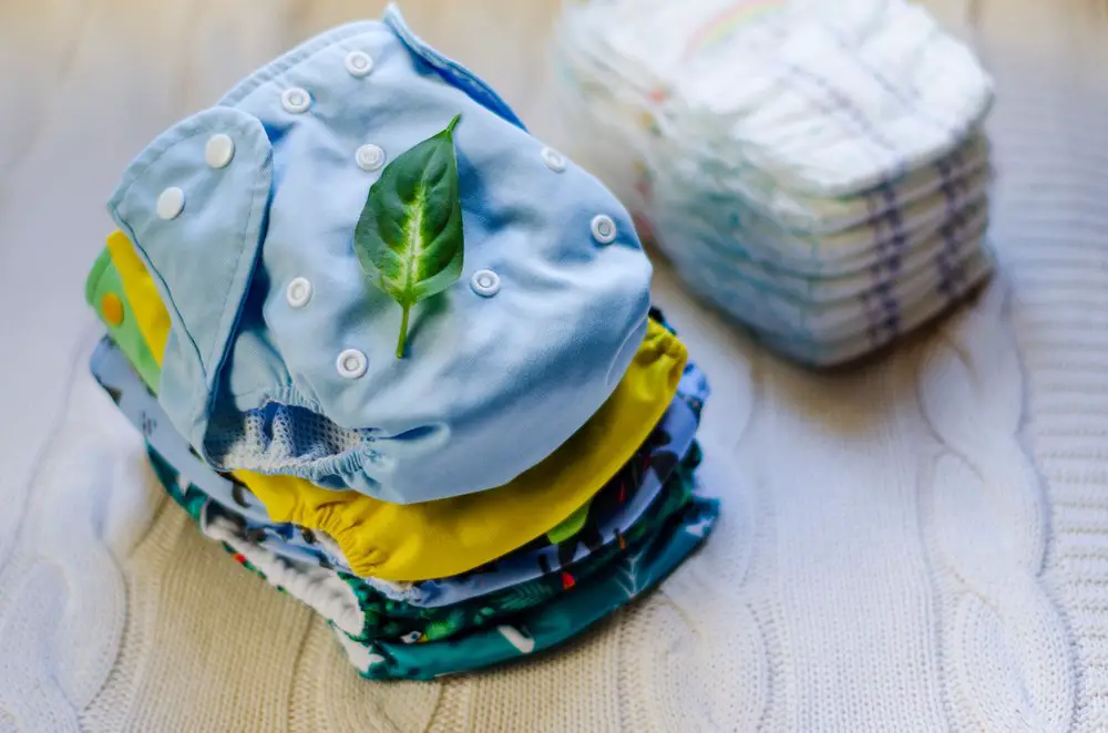 Stack of reusable nappies. Ecological trend for baby care. Washable cloth diapers. Eco friendly diapers vs pampers