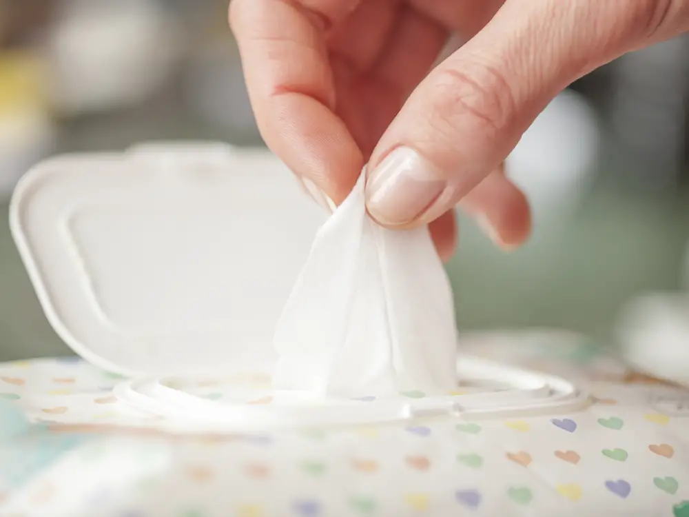 Gently Hand picked a wet wipes in package box, Wet wipes in a wo